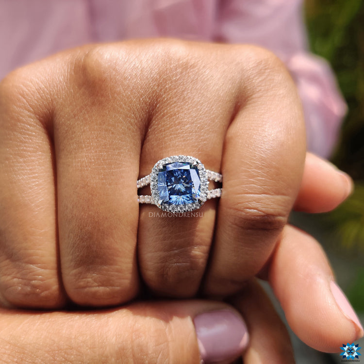 Handmade cushion cut moissanite ring with halo and elegant 4 claw prong setting.
