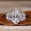 2 Carat Oval Diamond Ring with two half moon side stones, perfect for a unique engagement ring design.