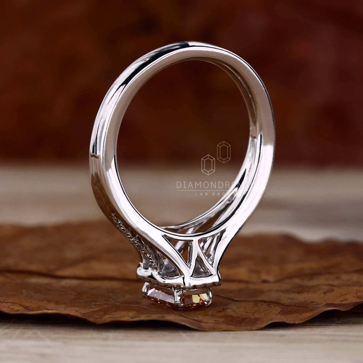 Halo ring with a radiant cut diamond centrepiece, surrounded by smaller diamonds for a dazzling effect.