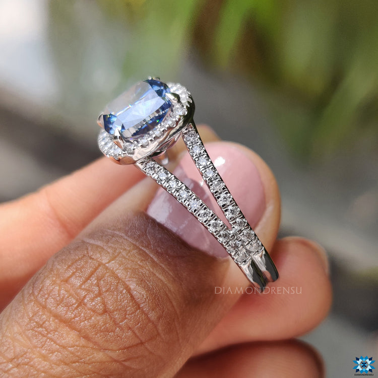 Handmade jewelry engagement ring with royal blue cushion cut moissanite and halo.