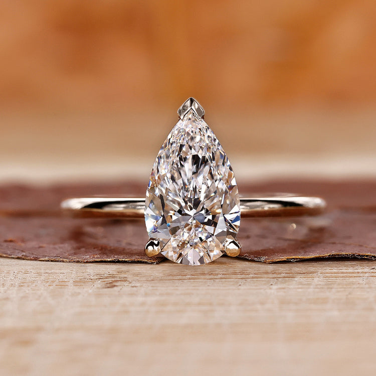 Pear cut diamond ring in a yellow gold setting.