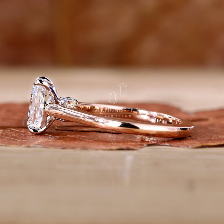 White gold ring with radiant cut center diamond.