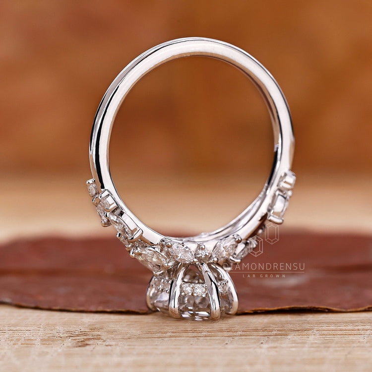 Prong setting ring with an oval step cut diamond centerpiece.