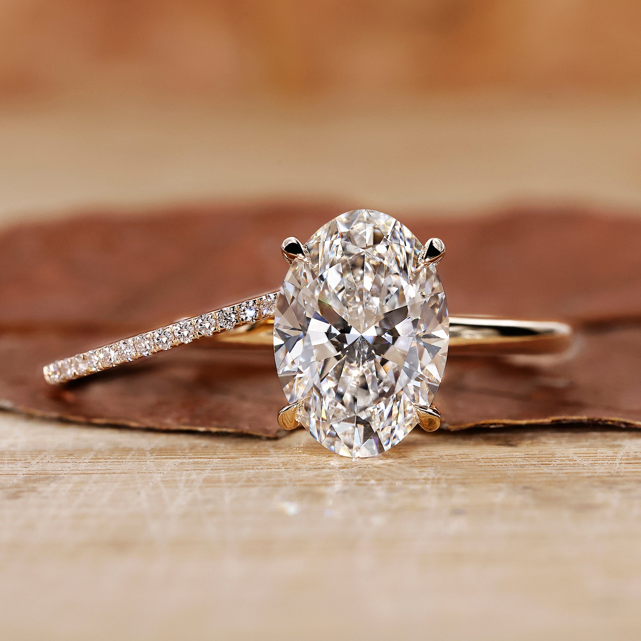 Oval engagement ring with wedding band in yellow gold bridal set.