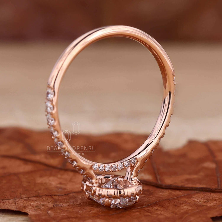 Luxurious oval diamond halo ring with a handmade design.