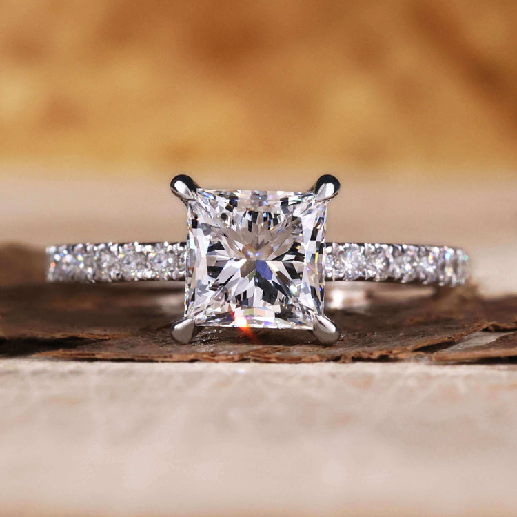 Princess cut pave engagement ring with intricate detailing and charm.