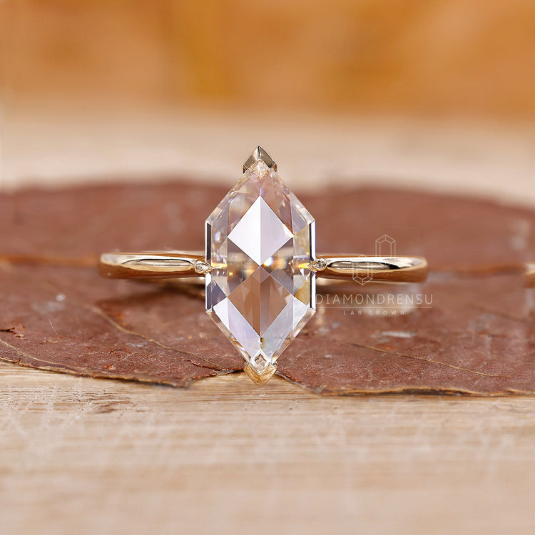 Yellow gold diamond ring with solitaire setting and open gallery design.