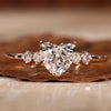 Heart shaped diamond ring with a stunning side stone design in a claw prong setting.