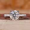 Round diamond engagement ring with pavé setting in white gold.