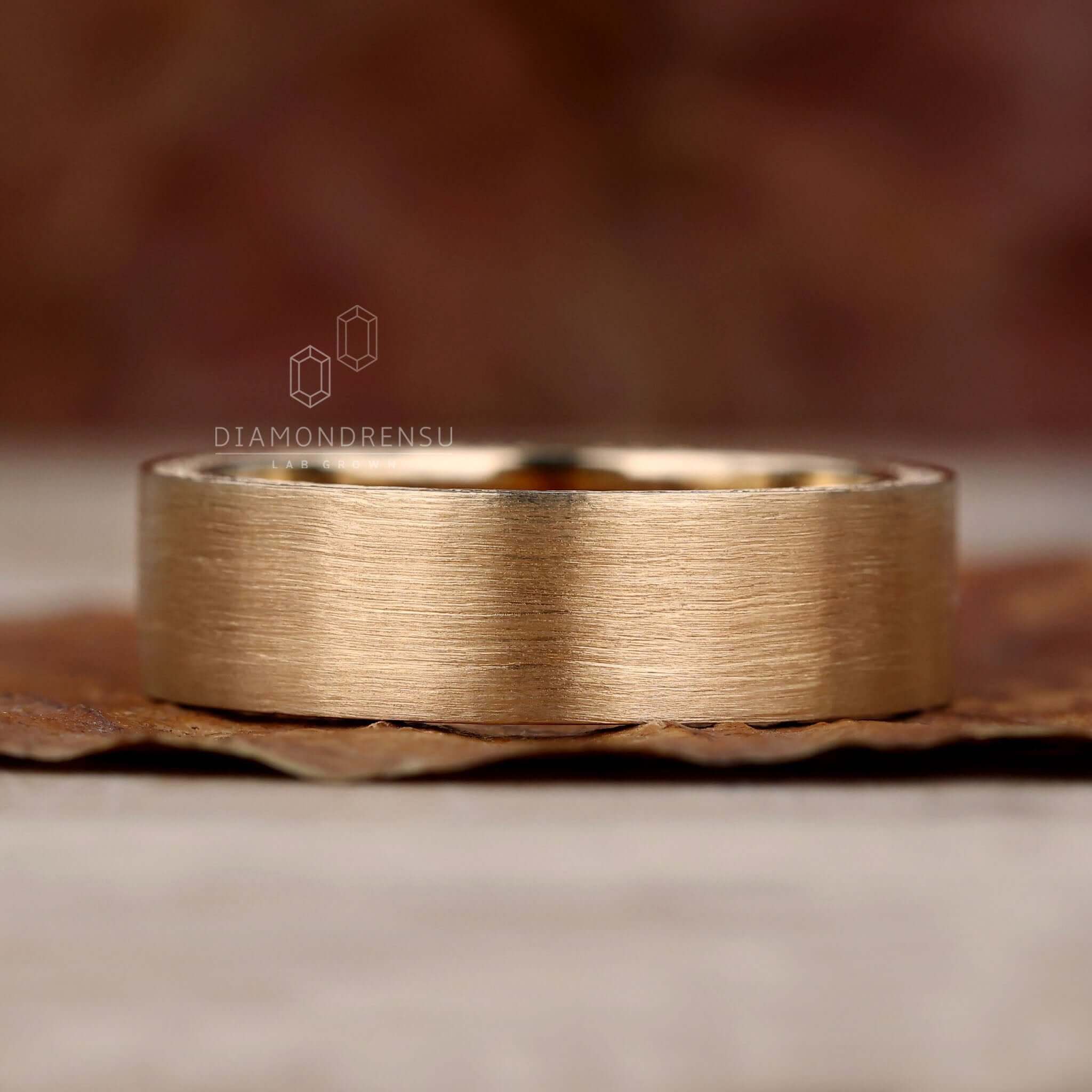 Gold wedding band for him, crafted for sophistication and charm.