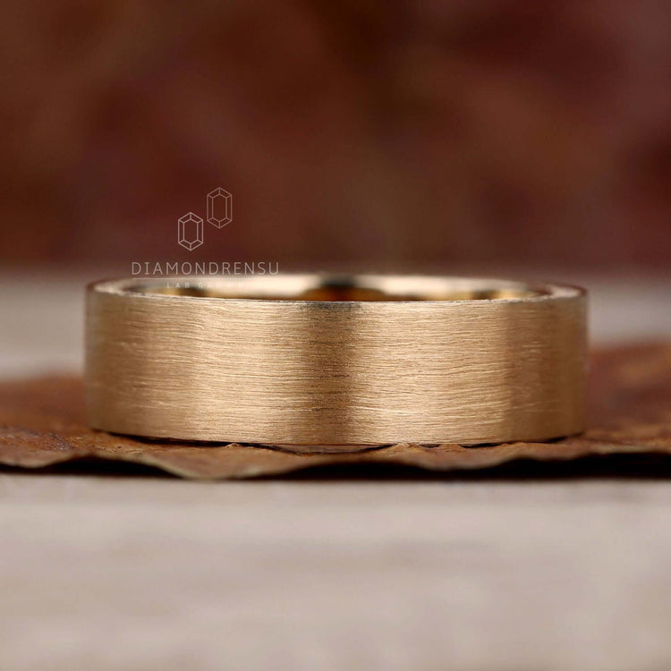 Gold wedding band for him, crafted for sophistication and charm.
