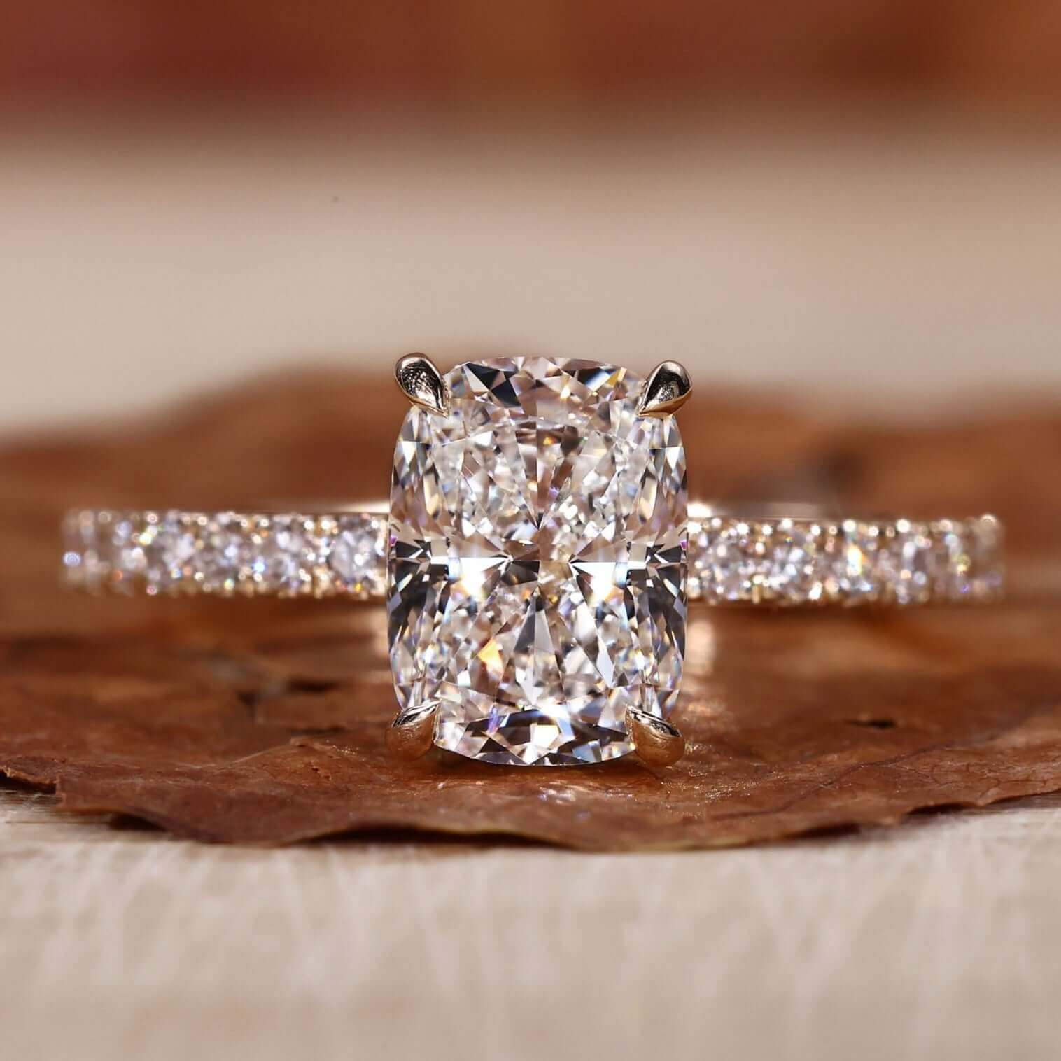 Cushion cut engagement ring with an elegant pave diamond ring design.