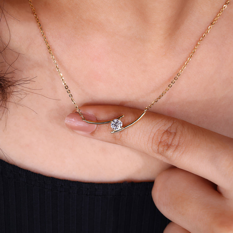 Round diamond pendant crafted in yellow gold with a dainty bar design.