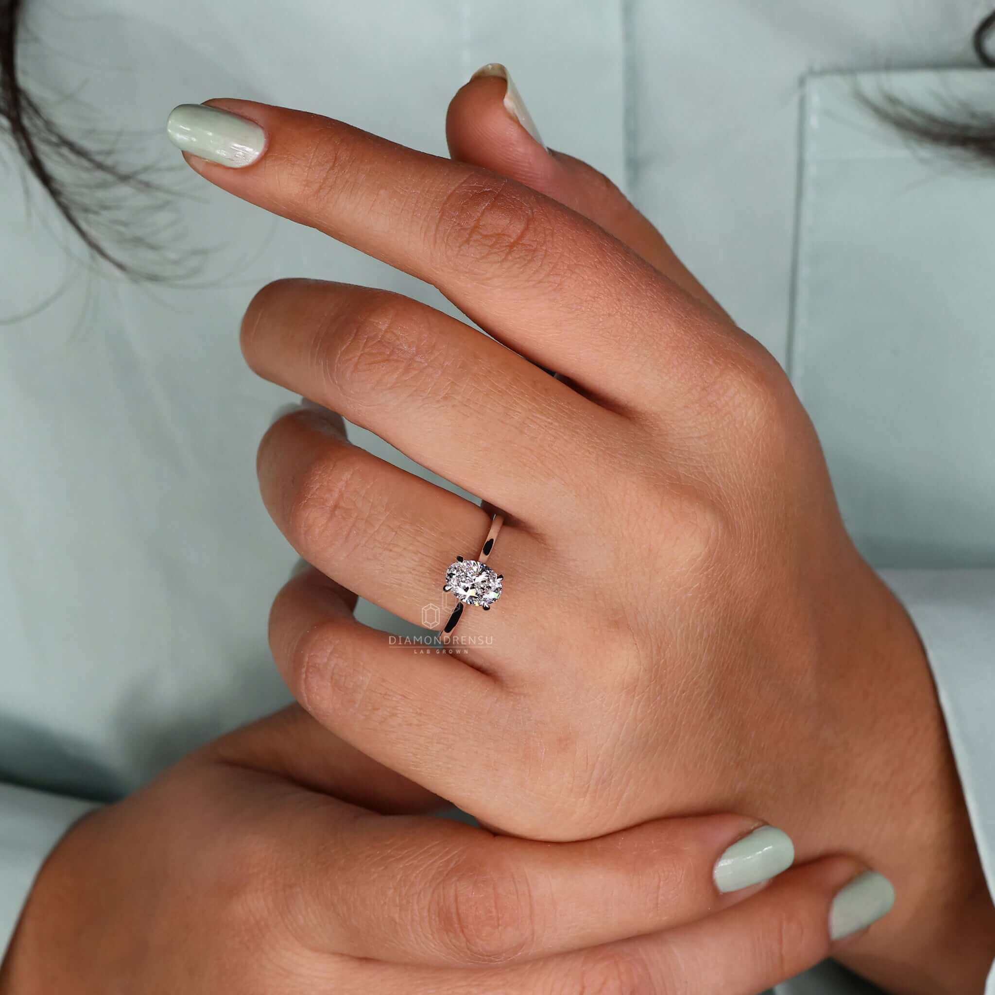Oval cut white gold engagement ring featuring an IGI certified diamond.