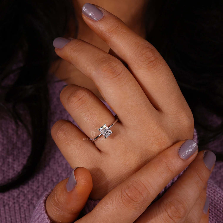 Gold solitaire engagement ring showcasing a classic 4-prong claw setting.