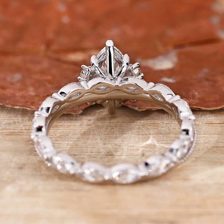Custom bridal set with marquise diamond and round side stones.