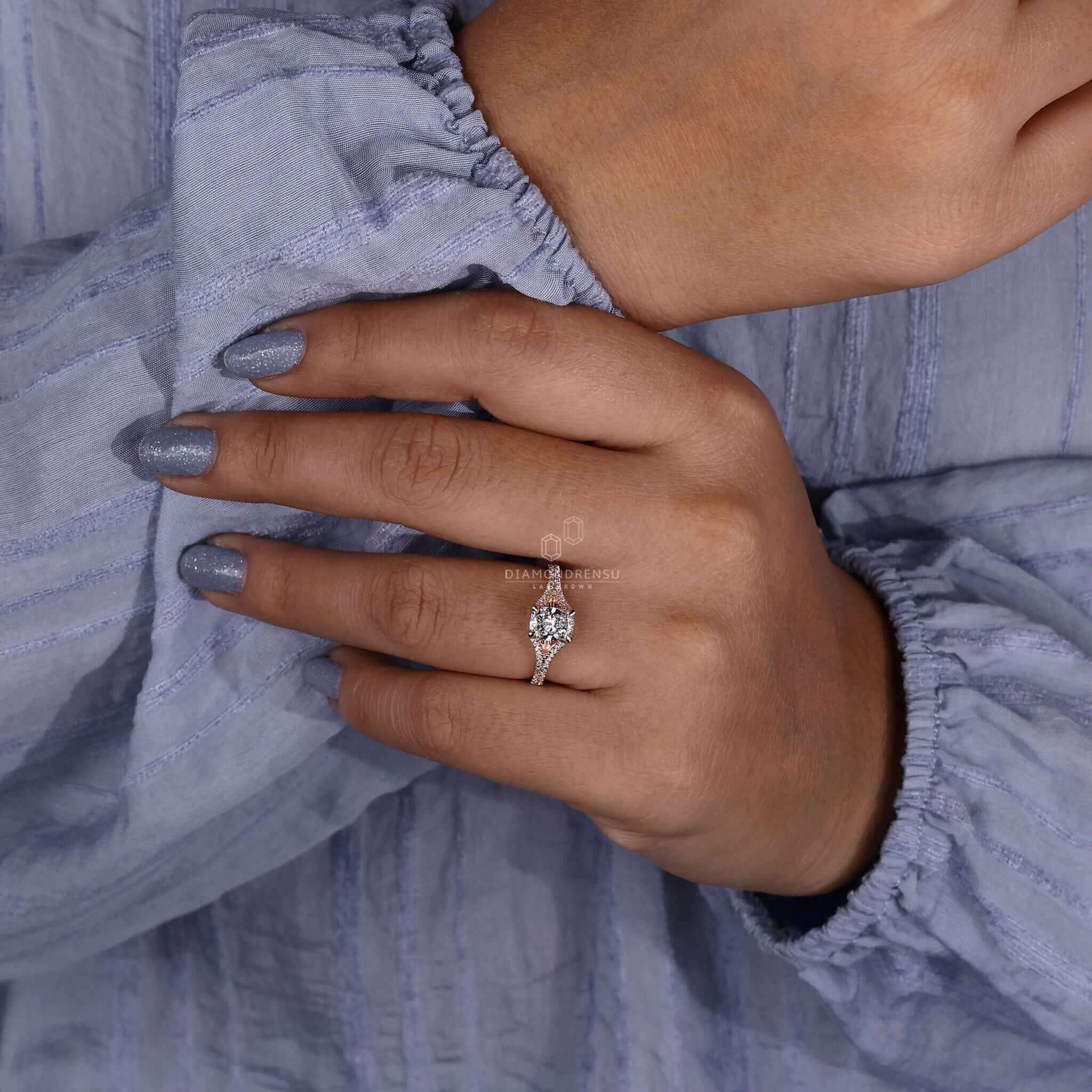 Unique engagement ring featuring a pave diamond ring design paired with a cushion cut diamond elongated style.