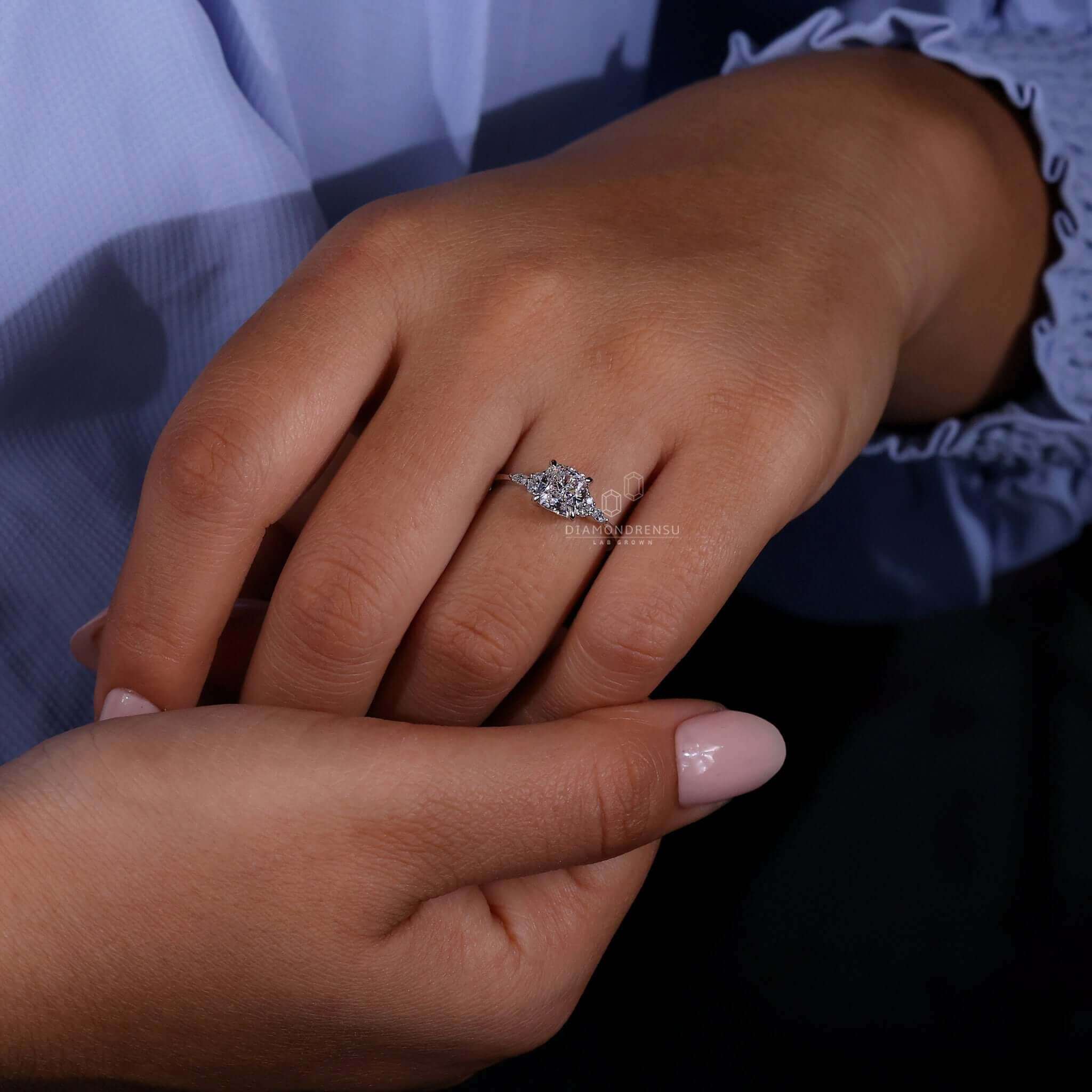 Cushion cut diamond ring with side stones, a timeless design for a unique engagement ring crafted in the UK.