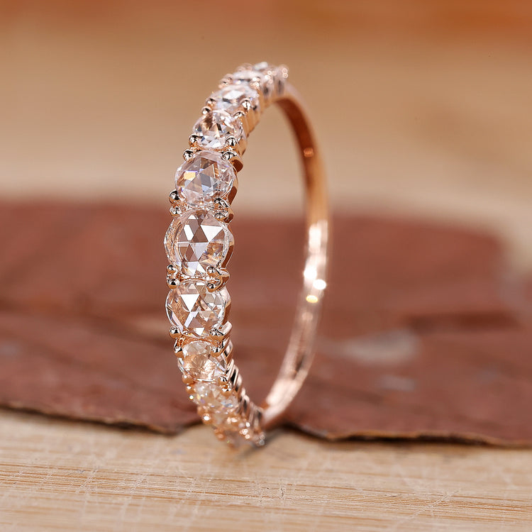 Round diamond wedding band in rose gold.