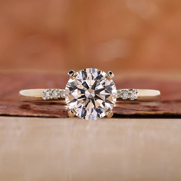 Round cut diamond ring with sparkling stones.