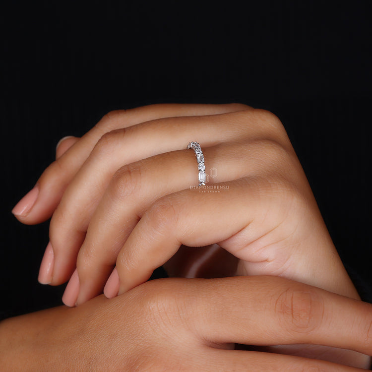 Elegant emerald and round cut eternity band.