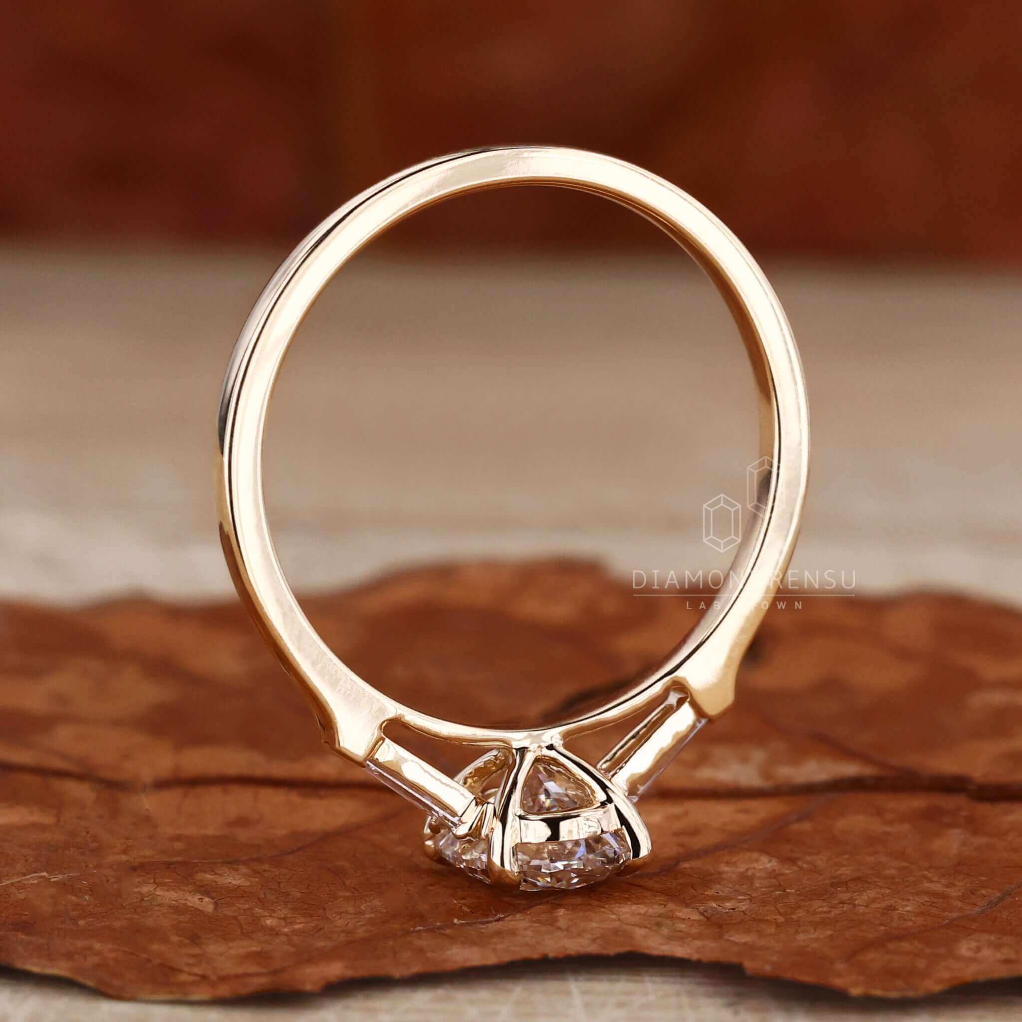 Three stone ring gold with a baguette diamond ring design, perfect as an engagement ring for women.