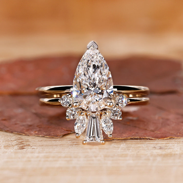 Pear shaped diamond ring with wedding band.
