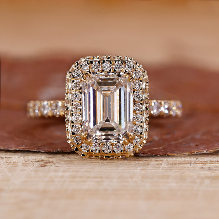 Emerald Halo Engagement Ring has a yellow gold ring and round cut diamond ring.