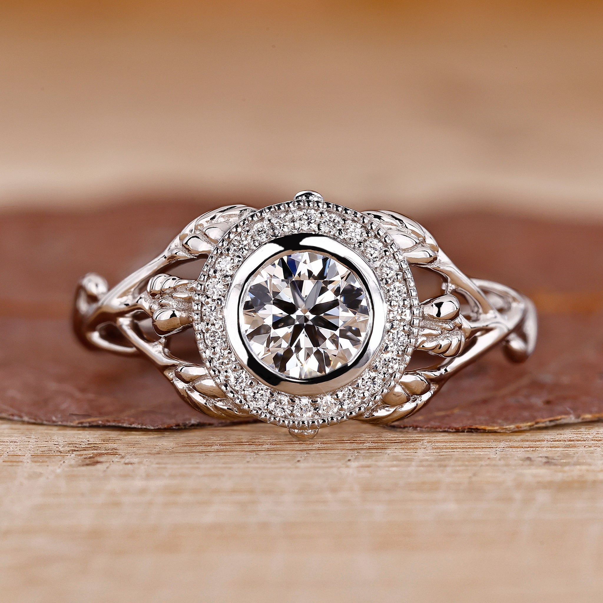 Nature inspired engagement ring with round brilliant cut diamond.