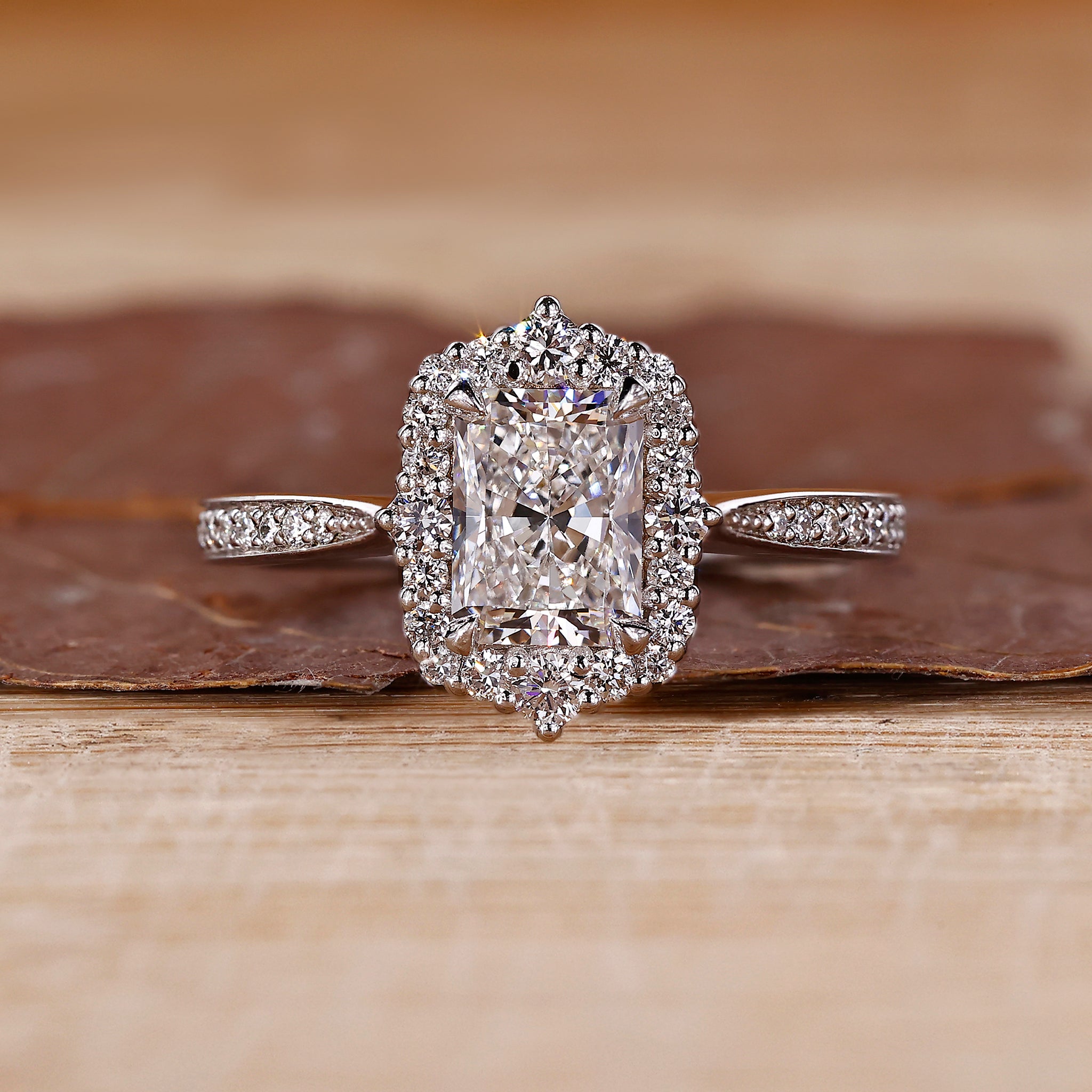 Radiant cut diamond ring with halo setting.