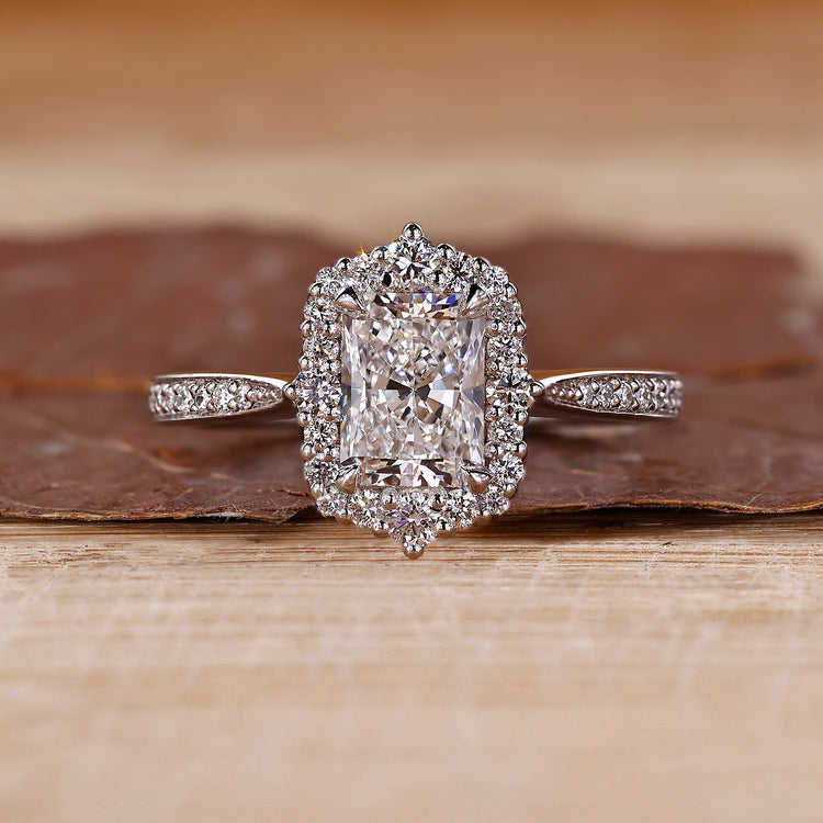 Radiant cut diamond ring with halo setting.