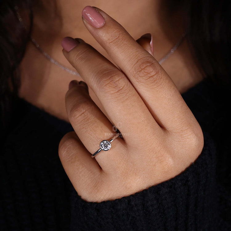 White gold bezel set diamond ring for sophisticated taste.