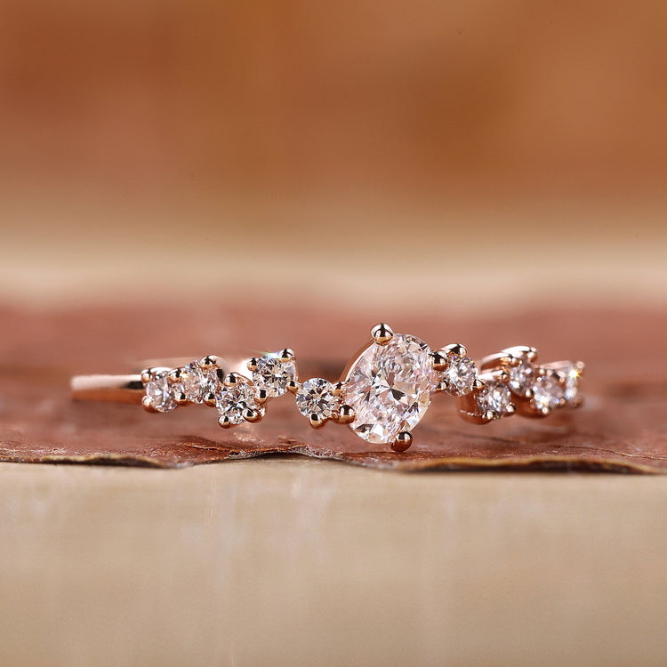 Oval diamond ring in rose gold setting.