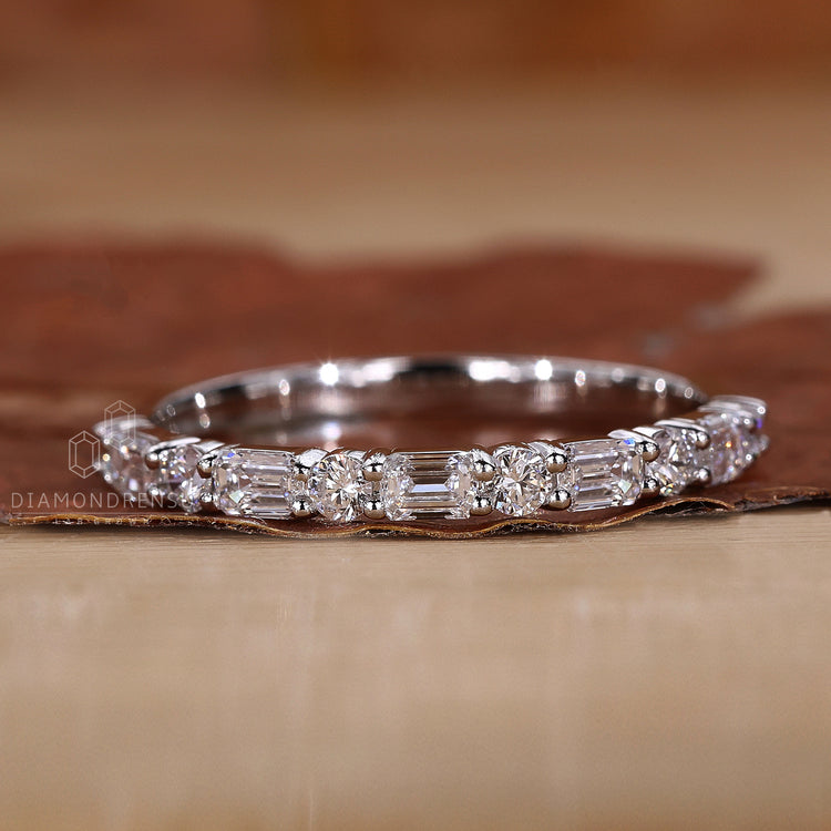 Unique emerald and round diamond band.