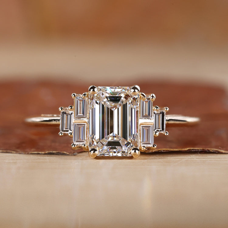 Emerald cut engagement ring with seven stone diamond ring.