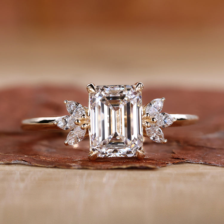 Emerald cut diamond ring in yellow gold setting.