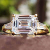Emerald cut moissanite ring with baguette side stones.