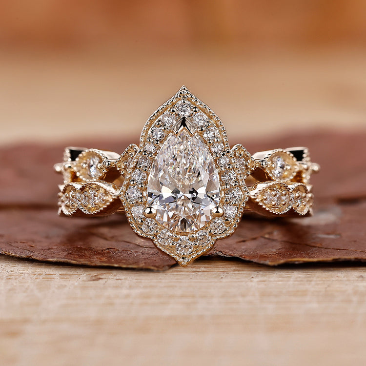 Vintage style bridal set with pear diamond ring and halo engagement ring.