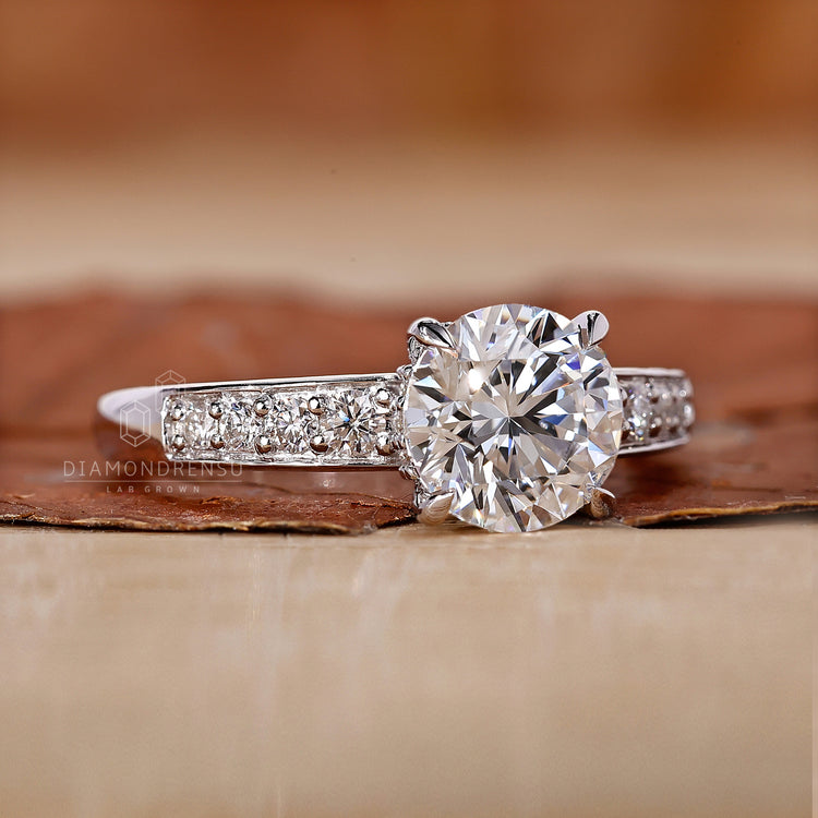 4 claw prong setting holds round cut side stones.