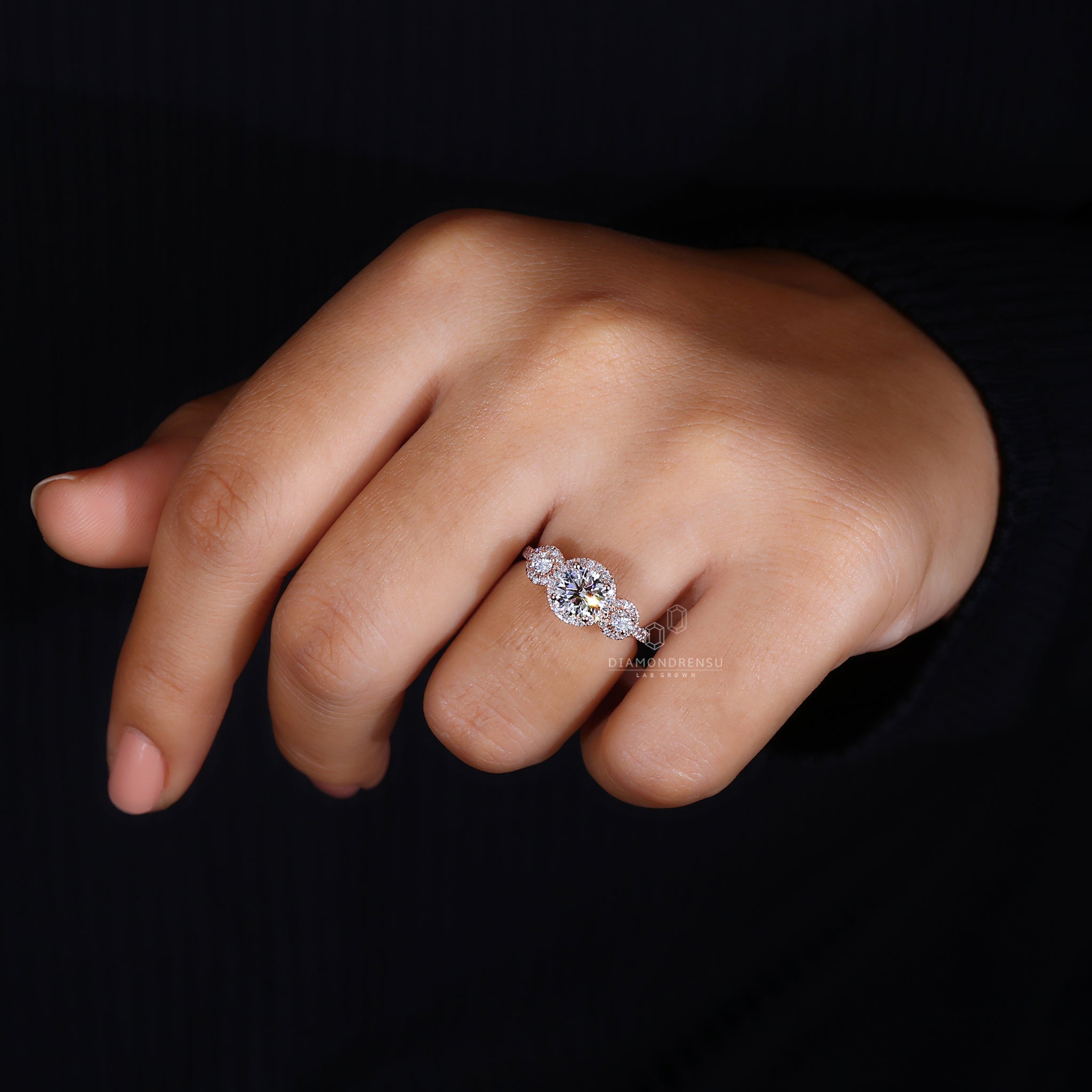 Rose gold engagement ring with halo accents.