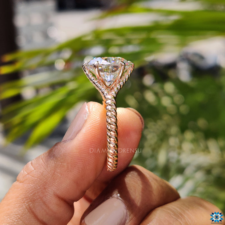 Elegant rose gold solitaire ring with brilliant round moissanite centre.