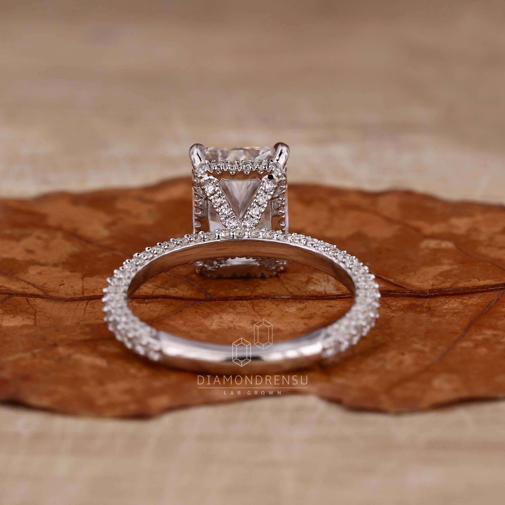 Radiant cut diamond ring featuring a handmade pave setting.