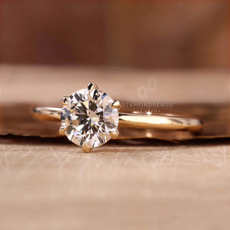 Solitaire gold engagement ring with a classic design for women.