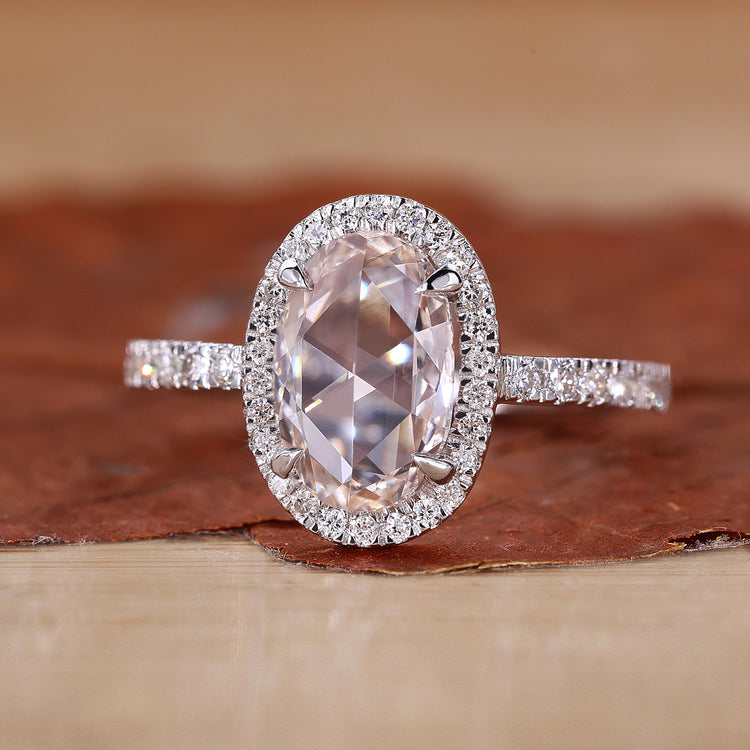 Oval rose cut diamond engagement ring with halo ring setting.
