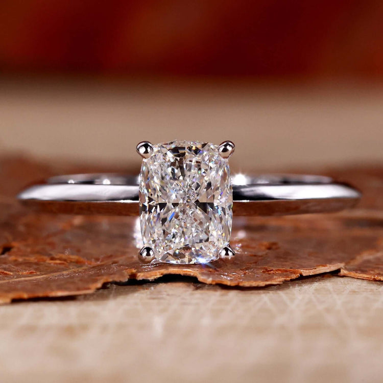Elongated cushion engagement ring featuring a knife edge ring shank for elegant design.