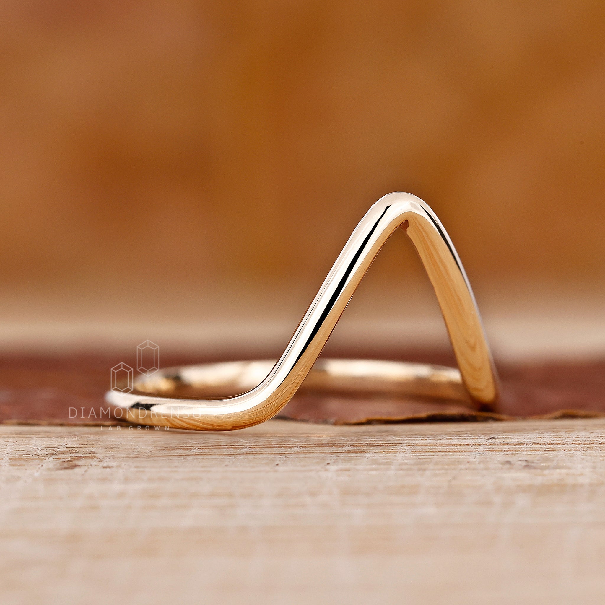 Custom wedding band created in a curved chevron silhouette.