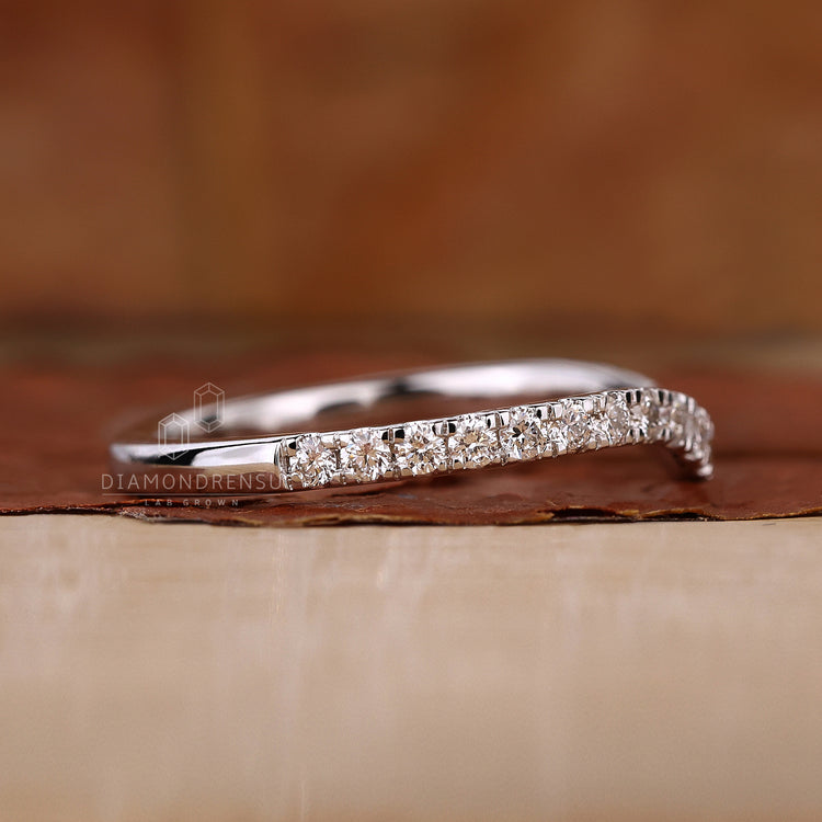 Elegant curved wedding band with lab grown diamonds.