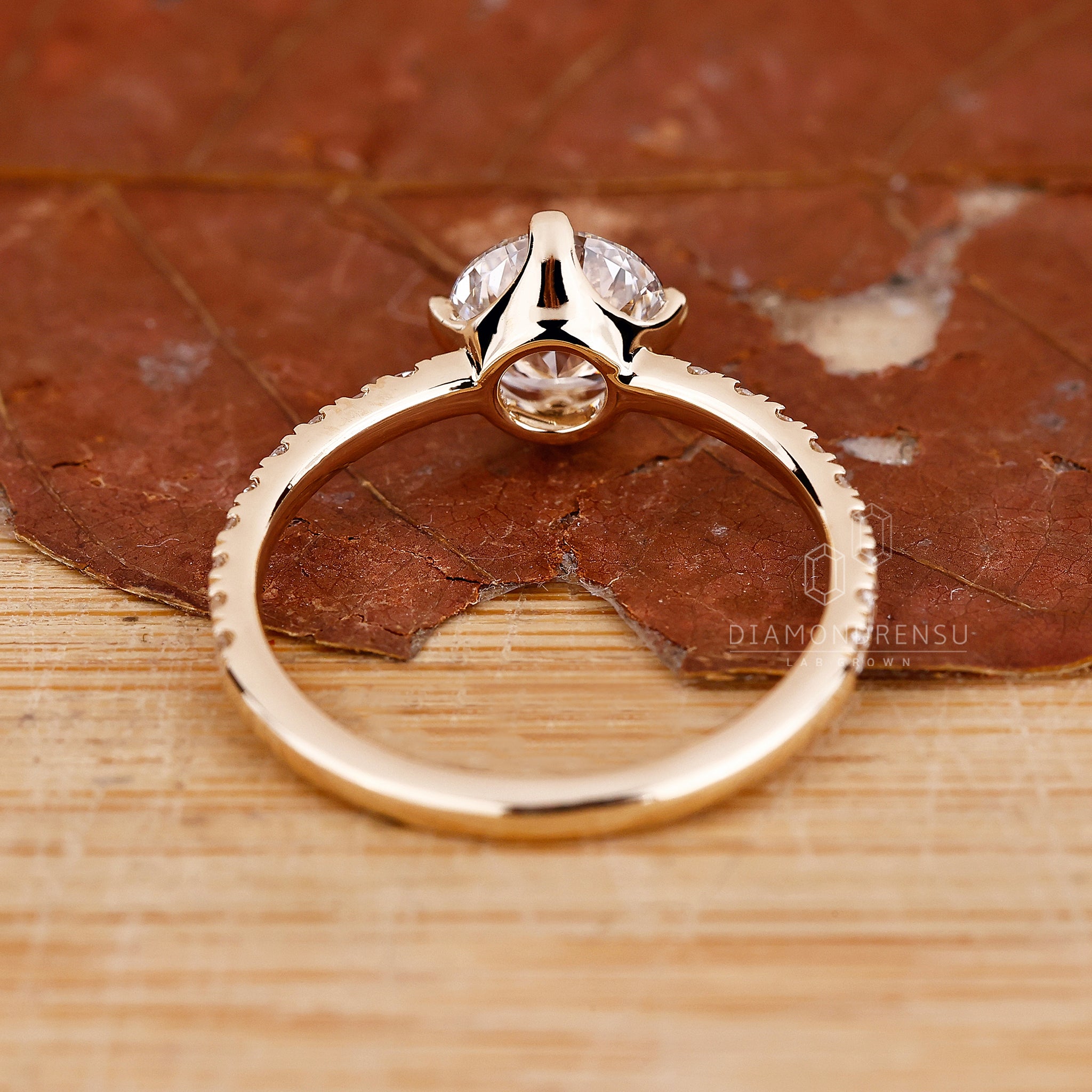 Yellow gold ring with round diamond and round diamond pave band.