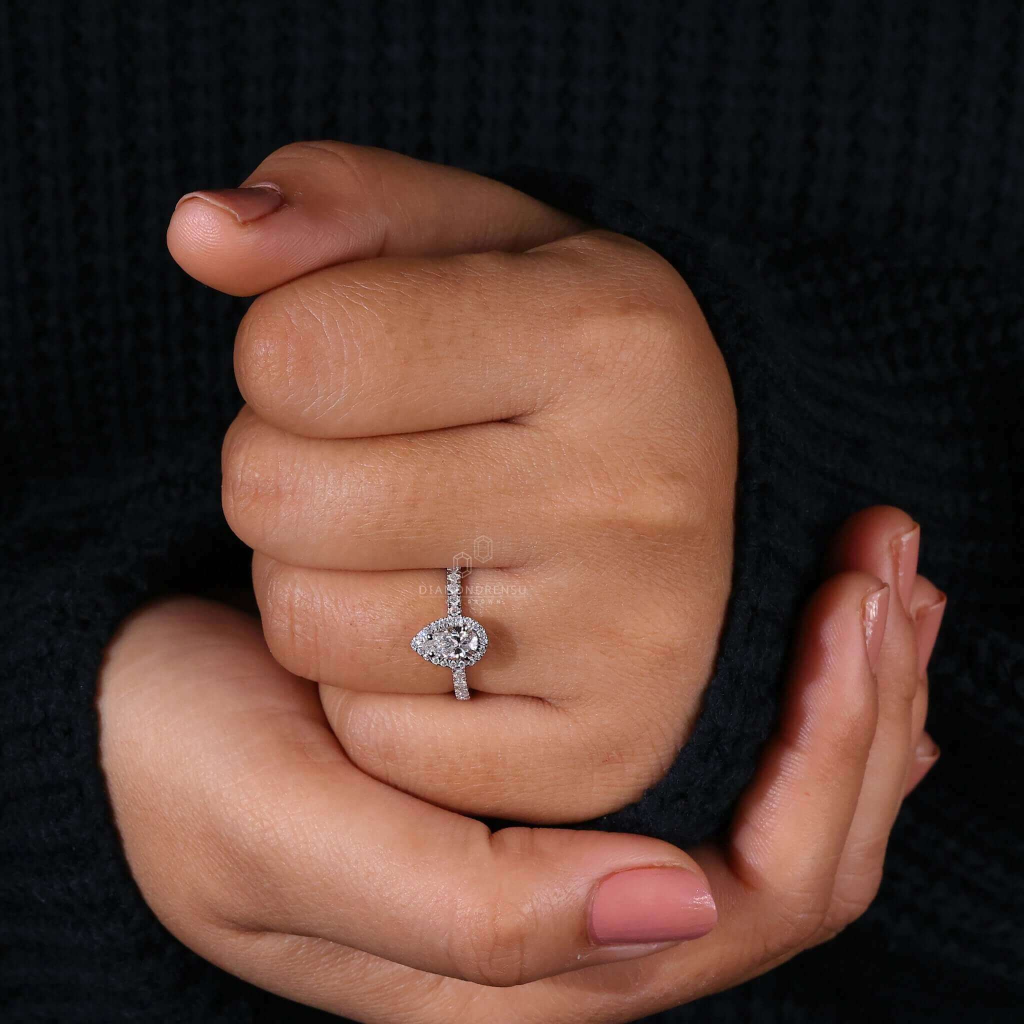 Pear shaped diamond ring with a classic 4 prong diamond ring setting for durability and elegance.