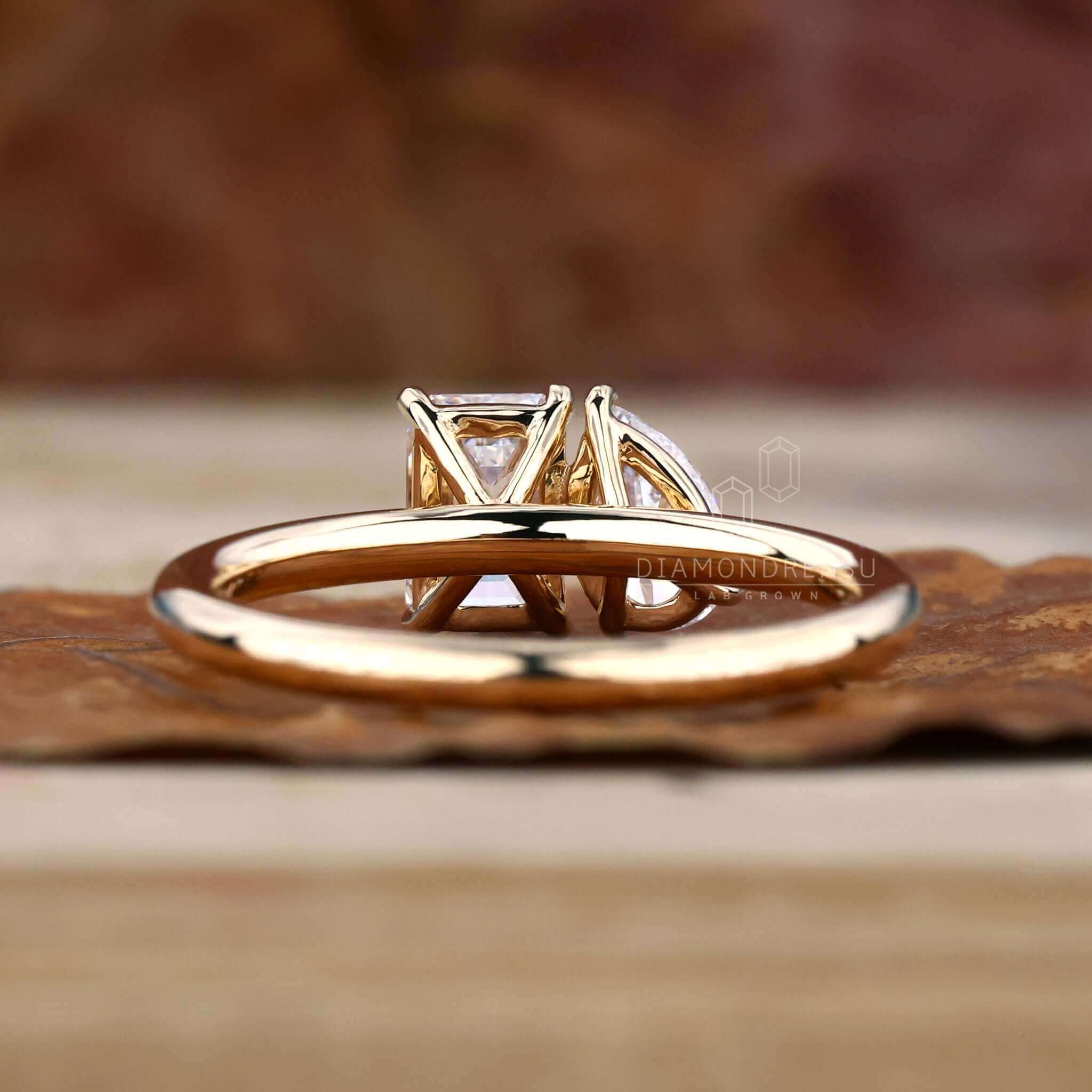 Emerald Cut Diamond in a moi et toi ring with a prong claw setting, perfect as a diamondrensu UK engagement ring.